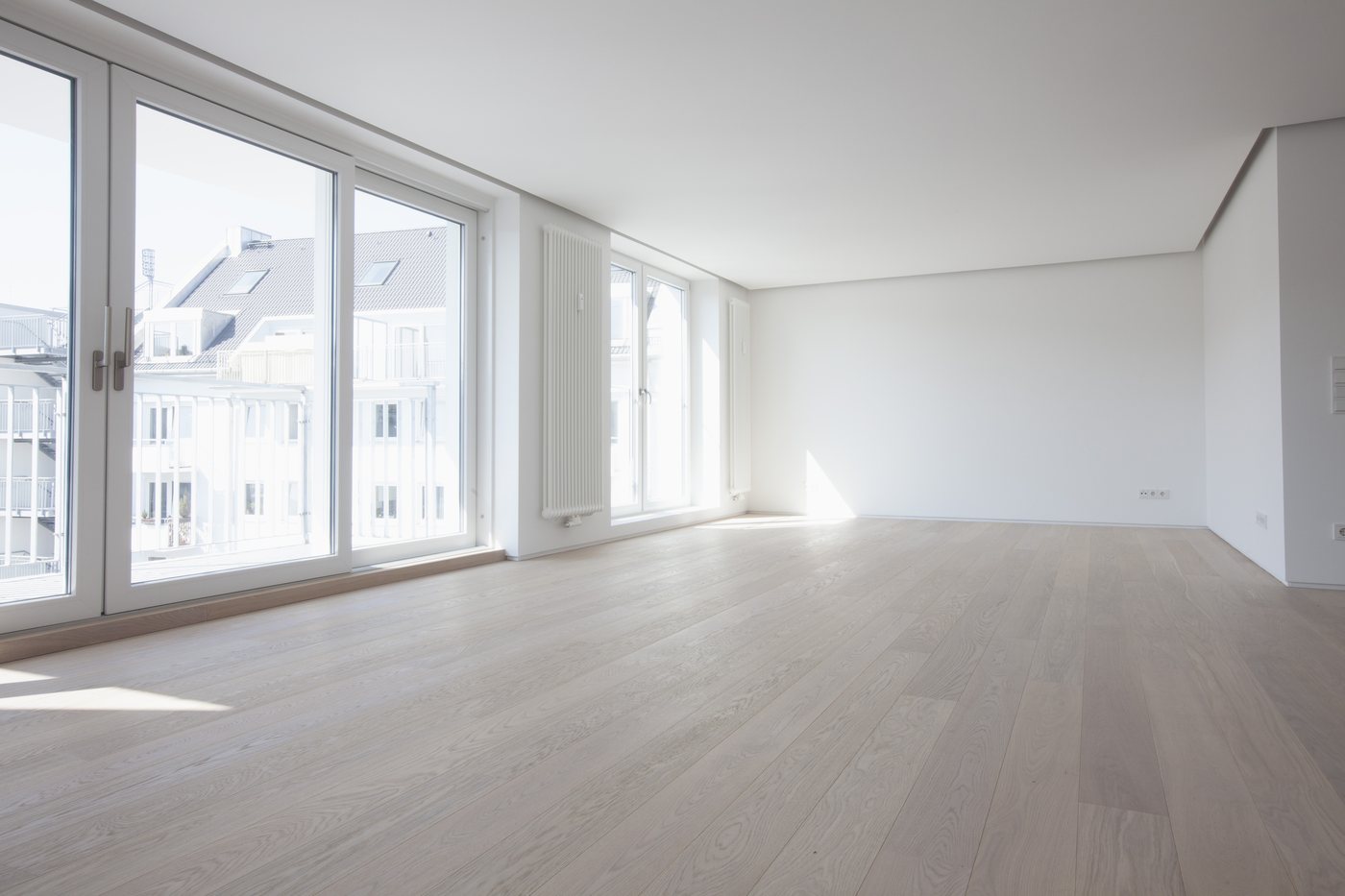 A light-filled living space with floor-to-ceiling windows, ready to be reimagined.